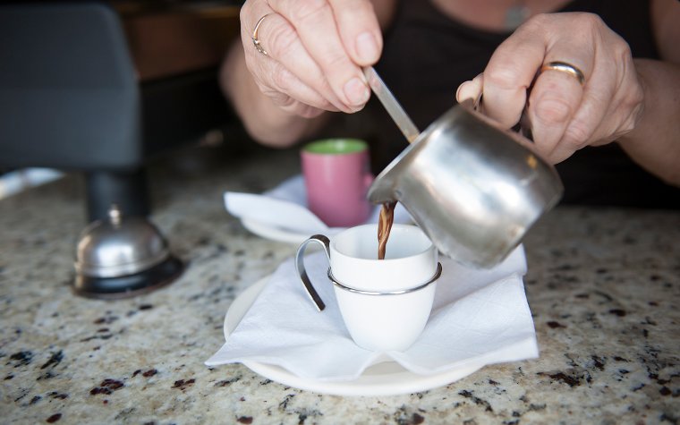 Pouring fresh Cuban coffee into a cup Pouring fresh Cuban coffee into a cup