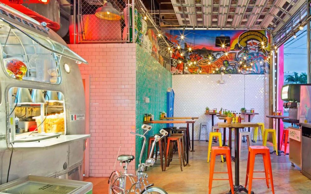 Bodega's front taco stand area and blue door leading to the speakeasy