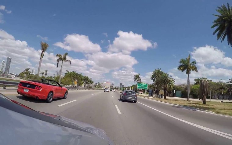 Cars driving along the road in Miami Cars driving along the road in Miami