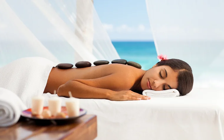 Woman receiving a hot stone massage on her back