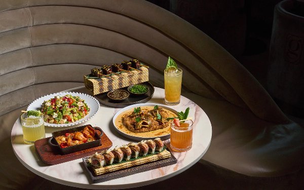 Table spread with luxury dishes at Giselle Restaurant in Miami