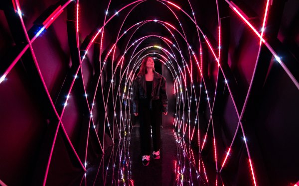 Woman walking through Magentaverse at Artechouse