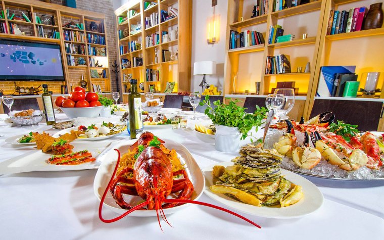 A variety of seafood dishes with sides at Estiatorio Milos A variety of seafood dishes with sides at Estiatorio Milos