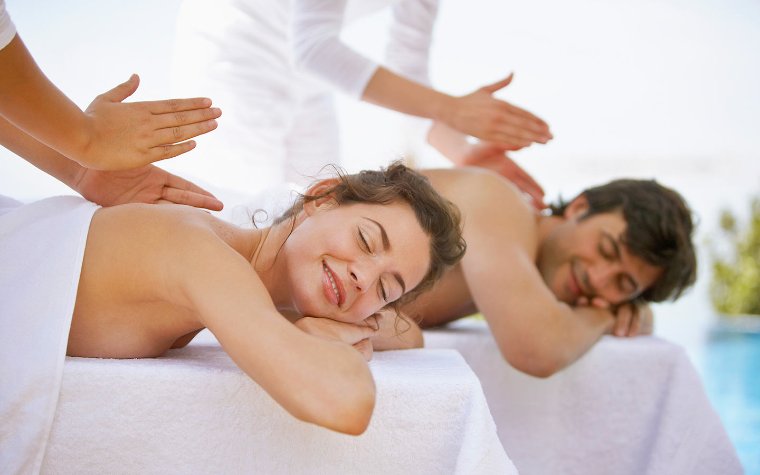 Couple enjoying a massage together Couple enjoying a massage together