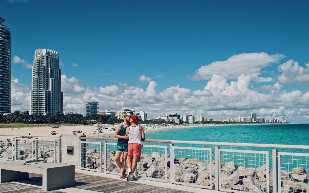 Two men kiss by the water in South Beach