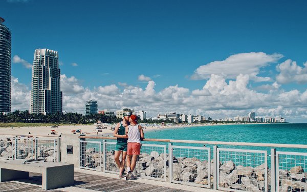 Two men kiss by the water in South Beach