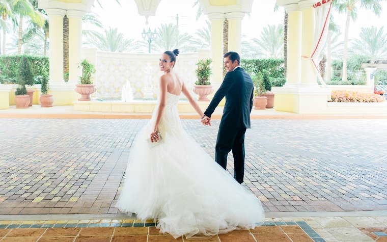 Wedding couple at Acqualina Resort, with grand architecture all around