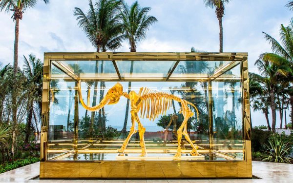 达米安·赫斯特 (Damien Hirst) 的“消失但未遗忘”金色猛犸象雕塑位于费纳 (Faena) 庭院