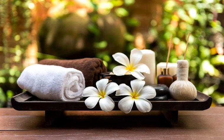 Candle and towels on a tray