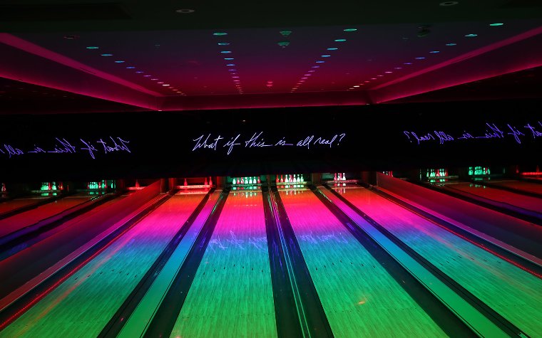 Basement's bowling lanes with glowing disco lights
