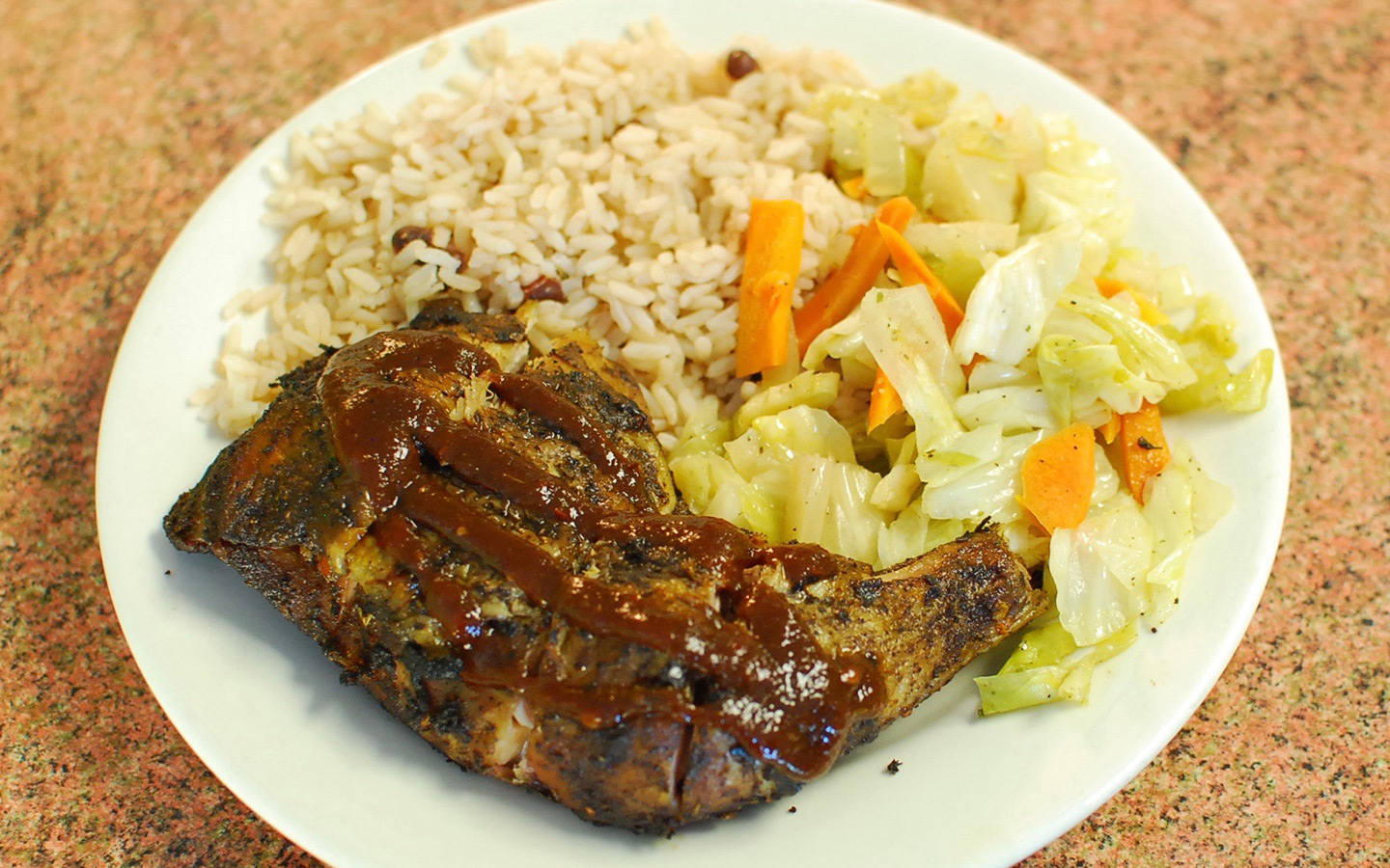 Delicious plate of jerk chicken served with rice and vegetables at Clive's Cafe Delicious plate of jerk chicken served with rice and vegetables at Clive's Cafe