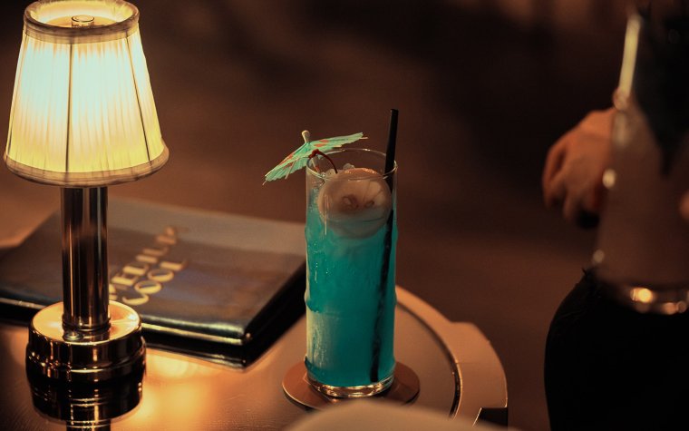 Blue tropical drink served with an umbrella at Medium Cool