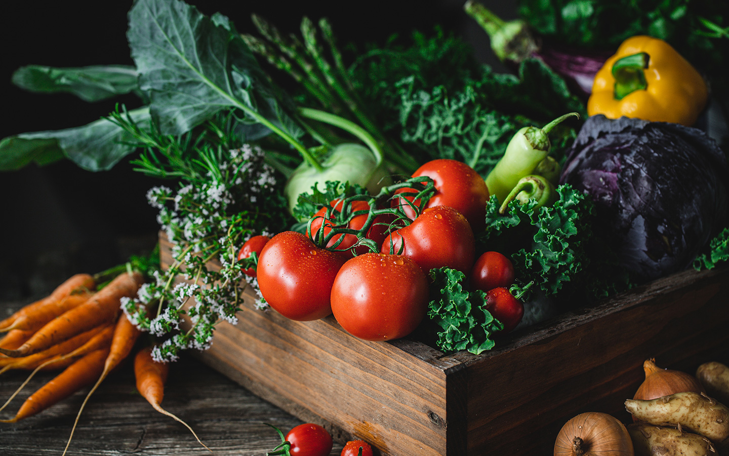 Basket of fresh tomatoes, peppers and greens