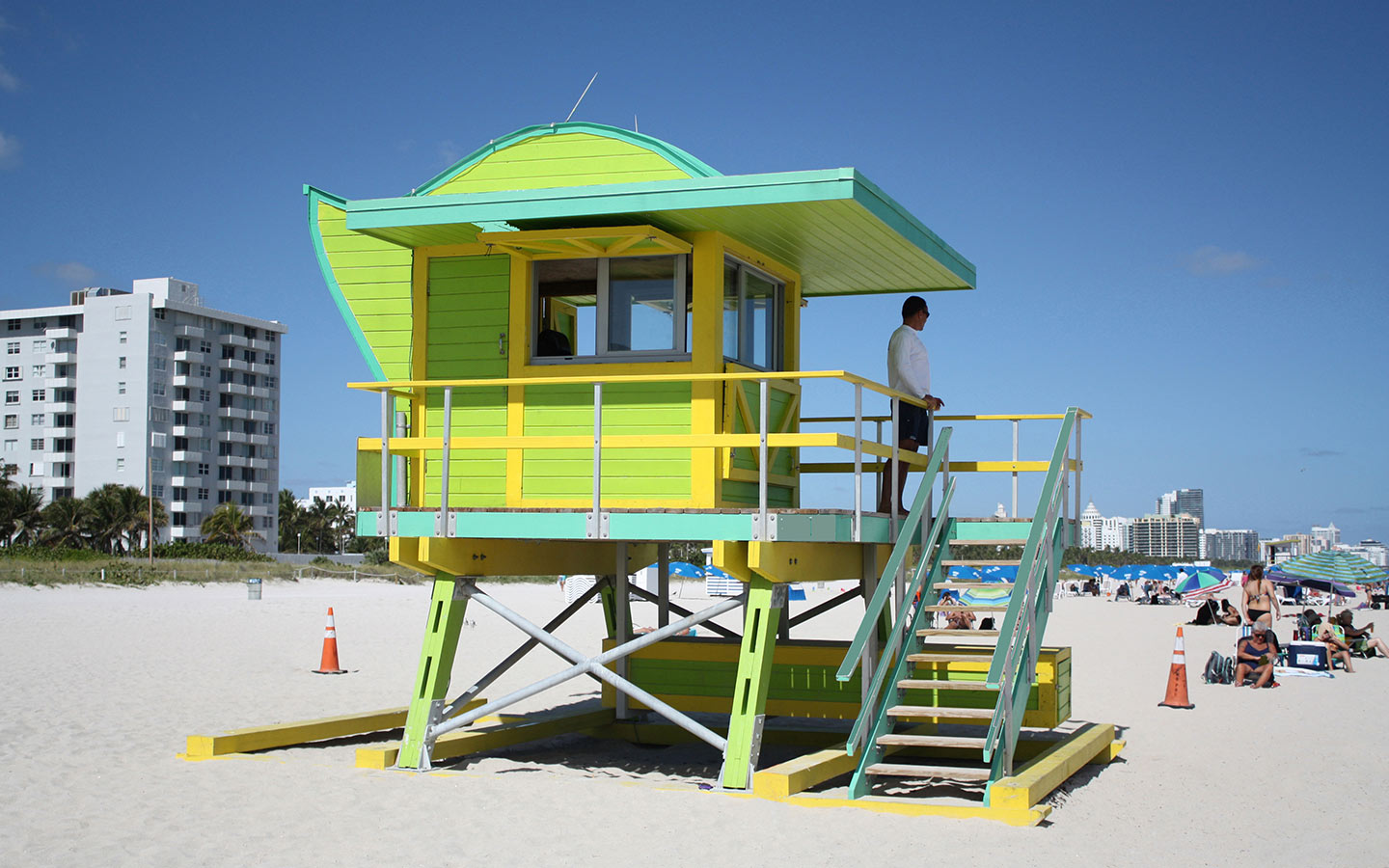 Life guard on yellow and green lifeguard stand Life guard on yellow and green lifeguard stand
