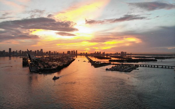 View from across the ocean of a spectacular sunset behind Downtown Miami