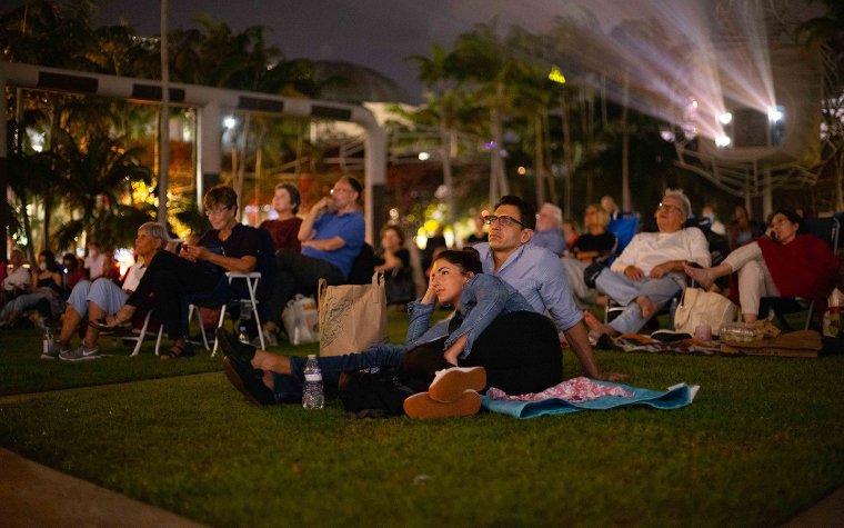 People watching an outdoor movie in SoundScape Park