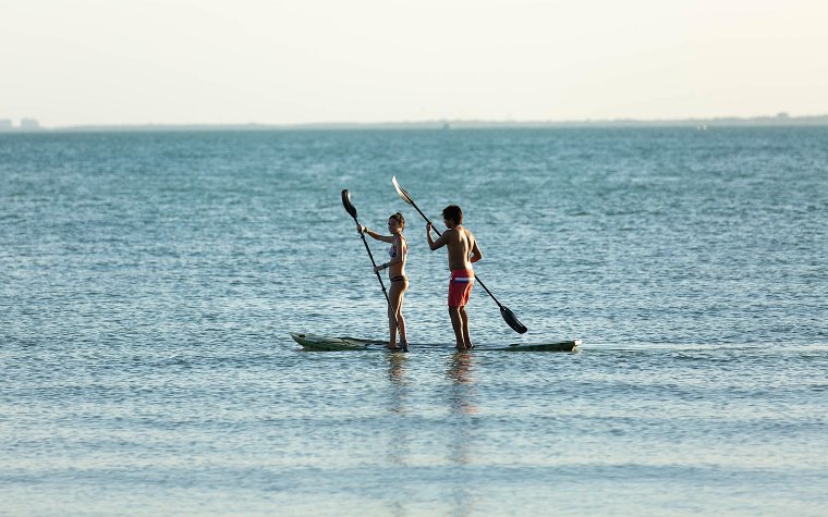 Couple doing standup paddleboarding