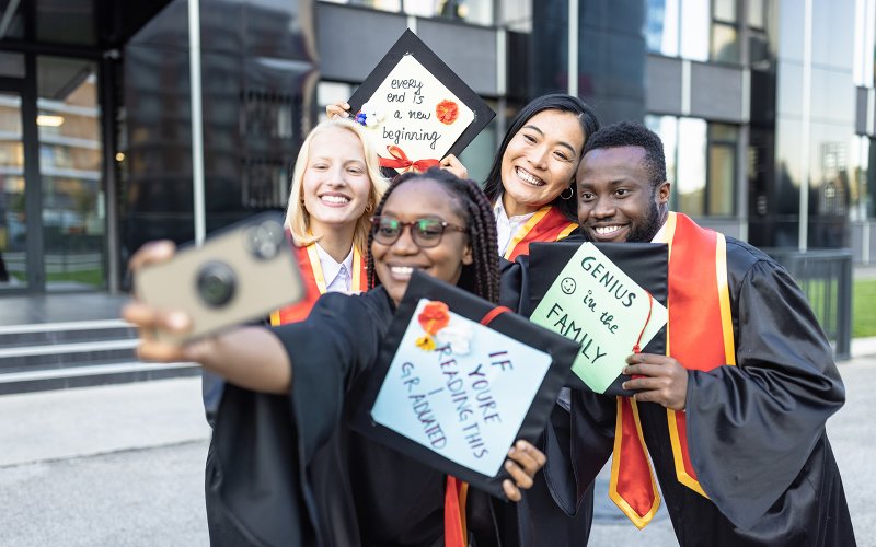 Graduate Students pose with diplomas