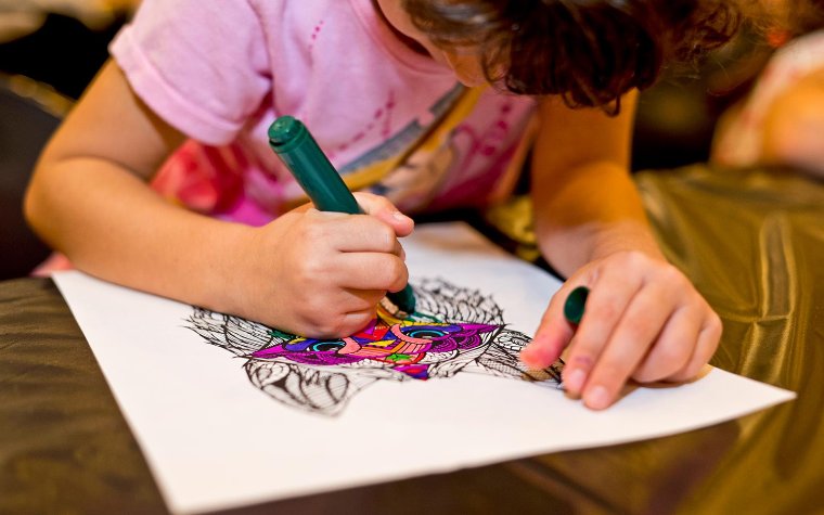 Child painting colorful art at HistoryMiami Museum