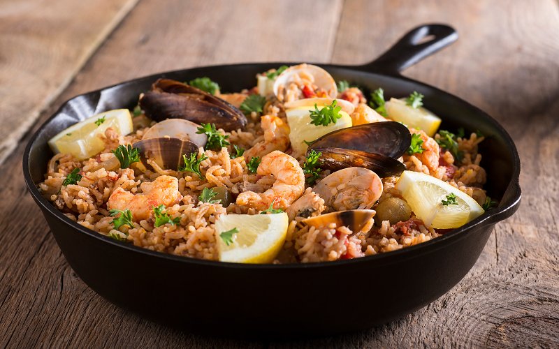 Paella with saffron rice, seafood, chicken, and spices
