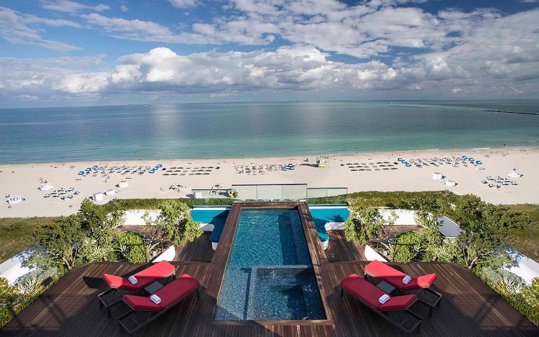 Rooftop pool at Hilton Bentley Miami South Beach with lounge chairs and beach views