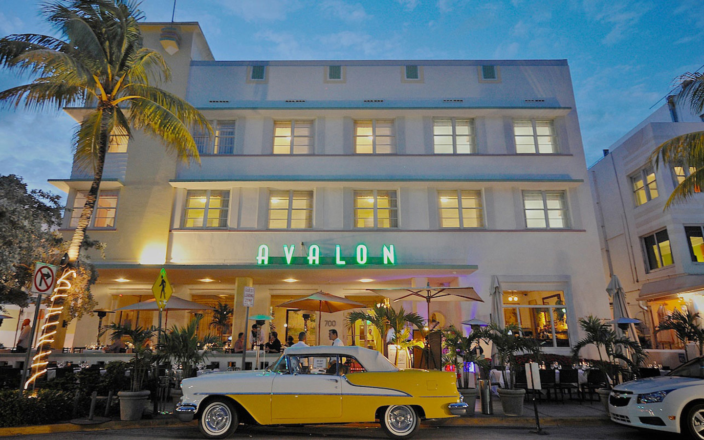 Avalon Hotel on Ocean Drive with a yellow antique car out front Avalon Hotel on Ocean Drive with a yellow antique car out front