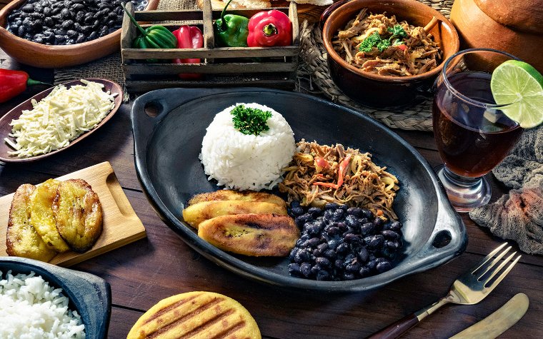Table spread with Latin-style pulled pork, rice, and beans
